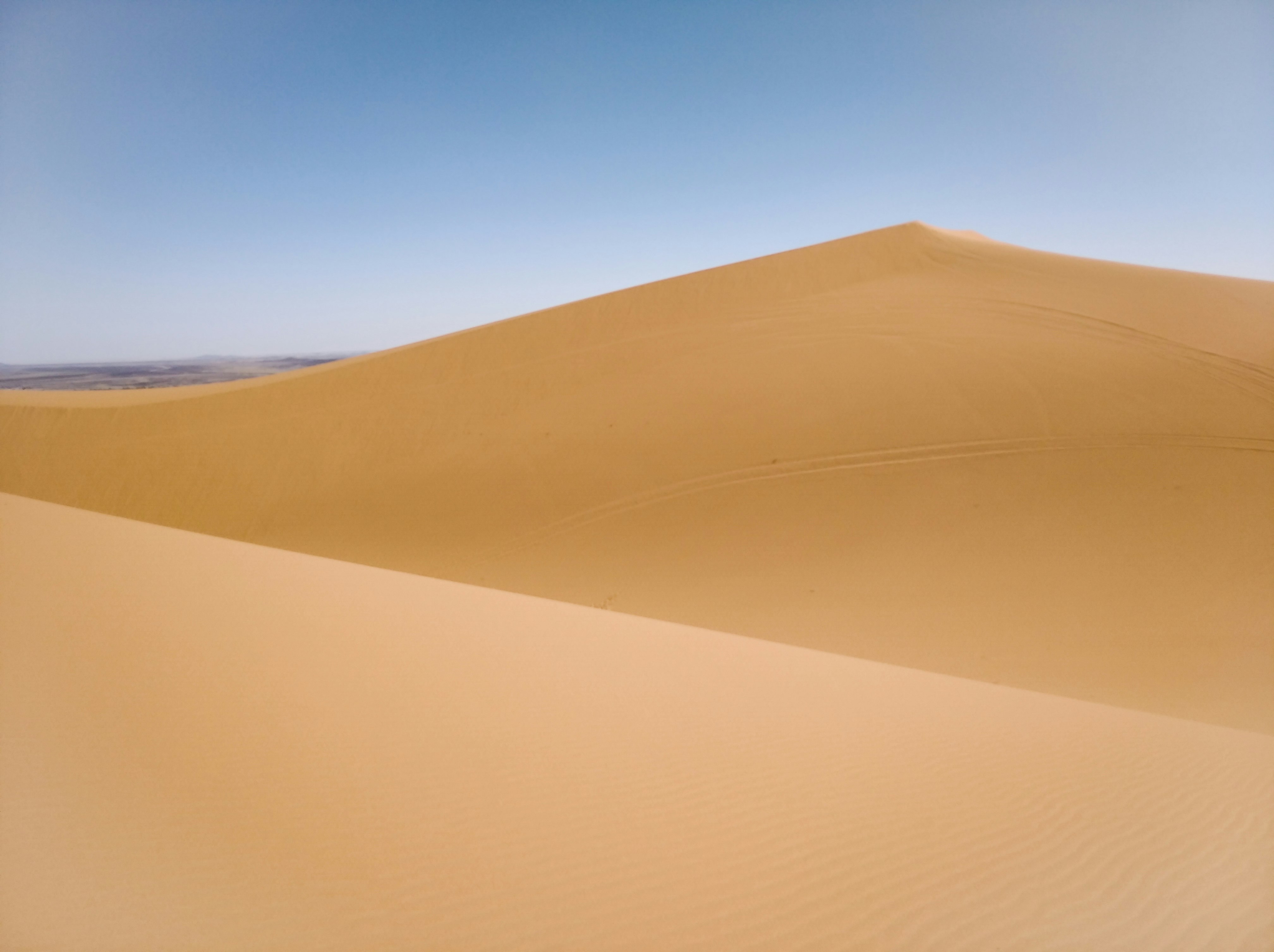 brown sand under blue sky during daytime